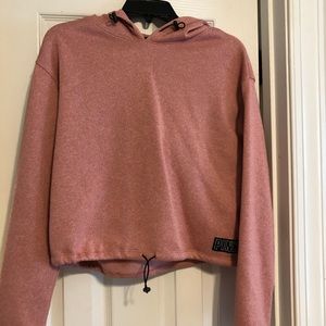 Pink cropped sweatshirt with hood.